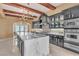 A spacious, upscale kitchen featuring granite counters, a kitchen island, and stainless steel appliances at 1795 Anelli Ct, Henderson, NV 89012