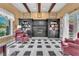 Cozy living room with fireplace, built-in bookshelves, and black and white tiled floor at 1795 Anelli Ct, Henderson, NV 89012