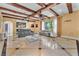 Elegant living room featuring beamed ceilings, stylish furnishings, and ample natural light at 1795 Anelli Ct, Henderson, NV 89012