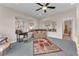 Inviting living room featuring a comfortable sofa, stylish decor, and a ceiling fan at 1795 Anelli Ct, Henderson, NV 89012
