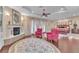 Cozy main bedroom showcasing a fireplace, sitting area, ceiling fan, and elegant décor at 1795 Anelli Ct, Henderson, NV 89012