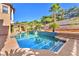 Picturesque pool area featuring mature palm trees, stone accents, and a serene outdoor space at 1795 Anelli Ct, Henderson, NV 89012