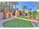 Exterior showcasing a well-manicured lawn, mature trees, and access to multiple outdoor spaces at 1795 Anelli Ct, Henderson, NV 89012