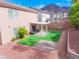 Mountain view backyard with artificial turf, stone pavers and patio cover at 189 Kings Canyon Court Ct, Henderson, NV 89012
