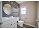 Well-lit bathroom featuring a modern vanity, toilet, and stylish floating shelves at 189 Kings Canyon Court Ct, Henderson, NV 89012