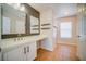Bathroom features a long vanity with double sinks, decorative shelves, and tile flooring at 189 Kings Canyon Court Ct, Henderson, NV 89012