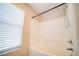 Bright bathroom featuring a shower-tub combo with modern showerhead and tiled enclosure at 189 Kings Canyon Court Ct, Henderson, NV 89012