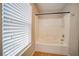 Bathtub and shower featuring an adjustable shower head and an exterior view through the window at 189 Kings Canyon Court Ct, Henderson, NV 89012