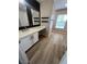 Modern bathroom featuring wood-style flooring, white vanity, and dark hardware accents at 189 Kings Canyon Court Ct, Henderson, NV 89012