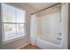 Bright bathroom featuring a shower-tub combo next to a window with exterior views at 189 Kings Canyon Court Ct, Henderson, NV 89012