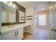 Well-lit bathroom featuring a sleek vanity with modern fixtures, shelving, and wood look flooring at 189 Kings Canyon Court Ct, Henderson, NV 89012