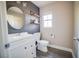Cozy bathroom featuring a white vanity, a round mirror, and natural light from the window at 189 Kings Canyon Court Ct, Henderson, NV 89012