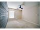 Bright bedroom with a wooden accent wall, plush carpet and a ceiling fan at 189 Kings Canyon Court Ct, Henderson, NV 89012