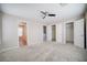 Spacious bedroom with neutral walls, plush carpet, ceiling fan and generous closet space at 189 Kings Canyon Court Ct, Henderson, NV 89012