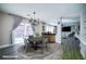 Dining area features a modern light fixture and sliding glass doors to the outdoor area at 189 Kings Canyon Court Ct, Henderson, NV 89012