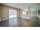 Open dining area with wood floors, a modern chandelier, and sliding glass doors to the backyard at 189 Kings Canyon Court Ct, Henderson, NV 89012
