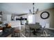 Charming dining room featuring a round table, a modern chandelier, and sleek hardwood floors at 189 Kings Canyon Court Ct, Henderson, NV 89012