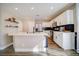 Modern kitchen with white cabinets, stainless steel appliances, and a breakfast bar at 189 Kings Canyon Court Ct, Henderson, NV 89012