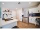 Bright kitchen features white cabinetry, stainless appliances, and quartz countertops at 189 Kings Canyon Court Ct, Henderson, NV 89012