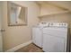 Convenient laundry room equipped with modern washer and dryer and storage shelf at 189 Kings Canyon Court Ct, Henderson, NV 89012