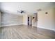 Bright living room with wood-like floors, a ceiling fan, and stylish wall decor at 189 Kings Canyon Court Ct, Henderson, NV 89012