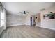 Open-concept living room with wood-look floors, accent wall, staircase, and tasteful decor at 189 Kings Canyon Court Ct, Henderson, NV 89012