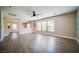 Spacious living room featuring wood-look floors, ceiling fan, and bright natural light at 189 Kings Canyon Court Ct, Henderson, NV 89012