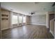 Bright living room with modern floors, stylish accent wall, and multiple windows at 189 Kings Canyon Court Ct, Henderson, NV 89012