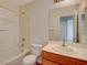 A full bathroom features a tub and shower combo, a wood vanity, and an oversized mirror at 209 Tainted Berry Ave, North Las Vegas, NV 89031