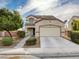 Charming two-story home with a two-car garage and well-maintained landscaping at 209 Tainted Berry Ave, North Las Vegas, NV 89031