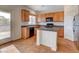 Bright kitchen features granite countertops, island, and stainless steel appliances at 209 Tainted Berry Ave, North Las Vegas, NV 89031