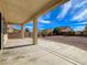 Covered outdoor patio for entertaining, complete with a concrete foundation and stucco columns at 209 Tainted Berry Ave, North Las Vegas, NV 89031