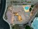 Aerial view of the sprawling property featuring desert landscaping, large pool, and a circular driveway at 211 Granite Ct, Boulder City, NV 89005