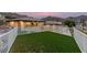 Backyard with artificial turf, desert landscaping, a white fence, and views of mountains at 211 Granite Ct, Boulder City, NV 89005