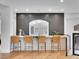 Modern bar area features stylish chairs, a sleek counter, and attractive backsplash for a chic entertaining space at 211 Granite Ct, Boulder City, NV 89005
