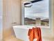Modern bathroom featuring a freestanding tub, large window with view, and stylish fixtures at 211 Granite Ct, Boulder City, NV 89005