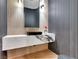Stylish powder room with textured walls, a floating vanity, and a modern vessel sink at 211 Granite Ct, Boulder City, NV 89005