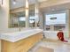 Luxurious bathroom featuring dual sinks, a soaking tub, and scenic views at 211 Granite Ct, Boulder City, NV 89005