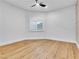 Minimalist bedroom with hardwood floors, large window with shutters, and neutral tones at 211 Granite Ct, Boulder City, NV 89005