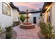 Charming courtyard featuring a decorative fountain, stone pathway, and lush greenery at 211 Granite Ct, Boulder City, NV 89005