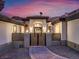 Elegant front entry showcases a well-lit walkway, decorative gate, and manicured landscaping at 211 Granite Ct, Boulder City, NV 89005