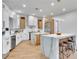 Bright, modern kitchen featuring white cabinets, stainless steel appliances, and a marble-topped island with seating at 211 Granite Ct, Boulder City, NV 89005