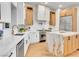 Modern kitchen features white cabinets, stainless steel appliances, marble countertops, and wood accents at 211 Granite Ct, Boulder City, NV 89005