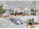 Open-concept living room with marble countertops, floor-to-ceiling windows, and a cozy seating area at 211 Granite Ct, Boulder City, NV 89005