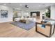 Open concept living area with modern furnishings, a stylish rug, and hardwood floors at 211 Granite Ct, Boulder City, NV 89005