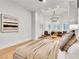 Bright main bedroom featuring a chandelier, hardwood floors, and comfortable seating area at 211 Granite Ct, Boulder City, NV 89005