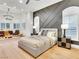Inviting main bedroom with accent wall, plantation shutters, and hardwood flooring at 211 Granite Ct, Boulder City, NV 89005