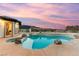Backyard featuring large pool, spa, rock details, desert landscaping, and mountain views at 211 Granite Ct, Boulder City, NV 89005