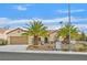 Charming single-story home featuring a well-manicured front yard, desert landscaping, and two palm trees at 2429 Wisconsin Dells Dr, Henderson, NV 89044