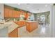 Bright kitchen featuring wood cabinets, granite counters, and a center island at 2429 Wisconsin Dells Dr, Henderson, NV 89044